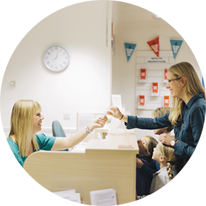 hospital staff taking a patient's credit card in order to process a pre-service payment at the front-desk.